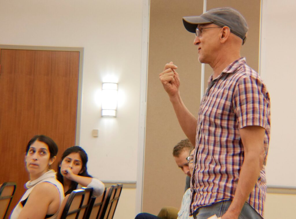Jose in a ballcap teaches acting class