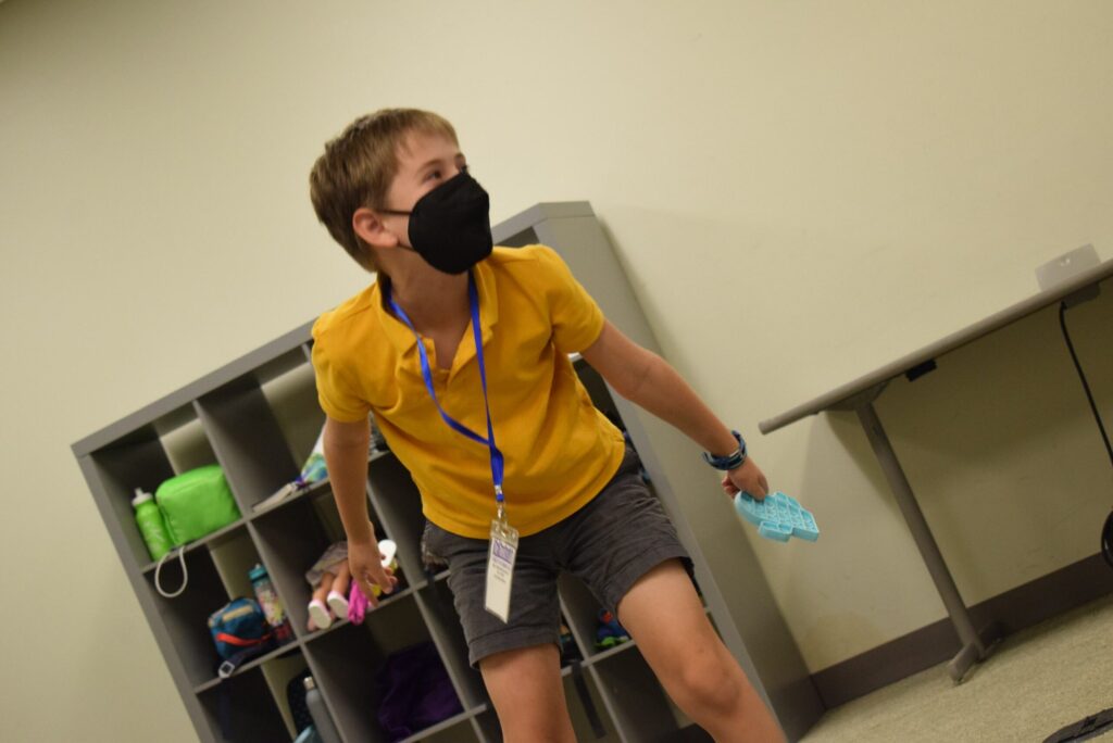 6th grade actor in yellow shirt and mask