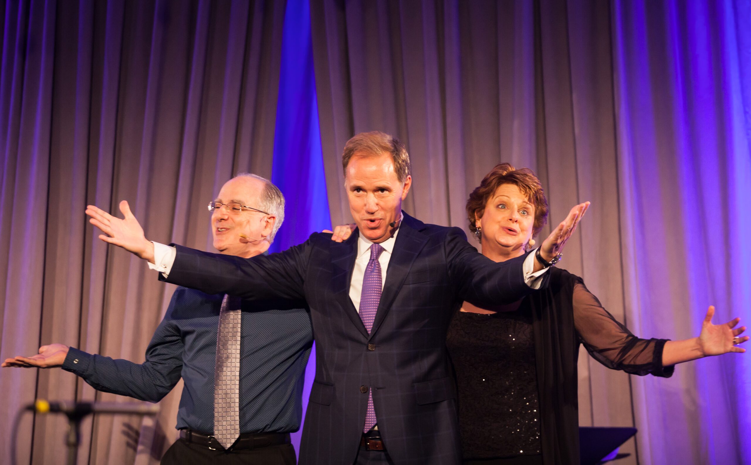 Jim Handley with Buzz and Deb on stage singing